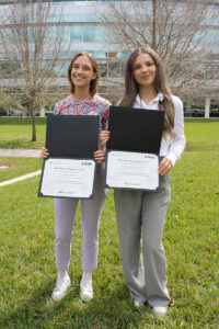 students holding certificates